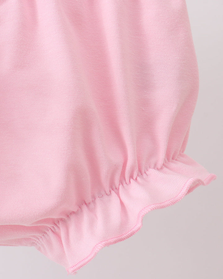 Pink baby bloomers on a light gray background