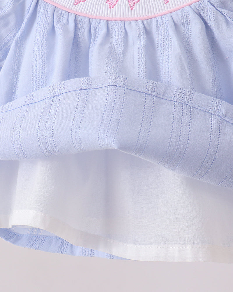 Light blue dress with a white inside skirt  against a white background