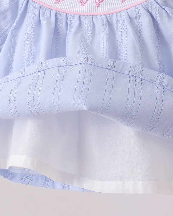 Light blue dress with a white inside skirt  against a white background