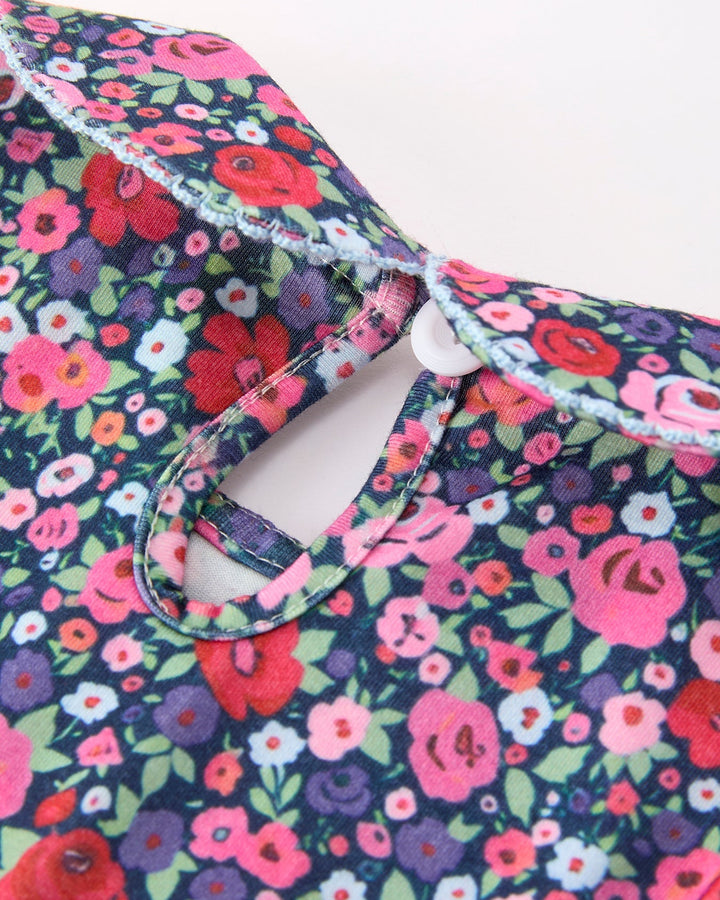 Floral dress neckline with tied light blue gingham bow and smocked collar