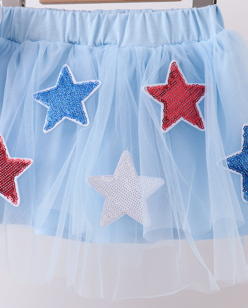 Light blue tulle skirt with red, white, and blue star patches on a white background