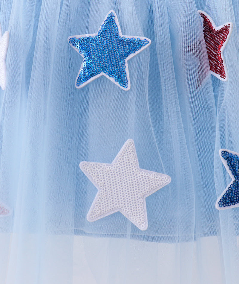 Light blue tulle fabric with star-shaped sequin patches in blue, white, and red.