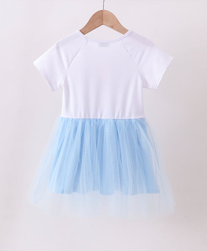 White top and light blue tulle skirt dress on a hanger against a white background