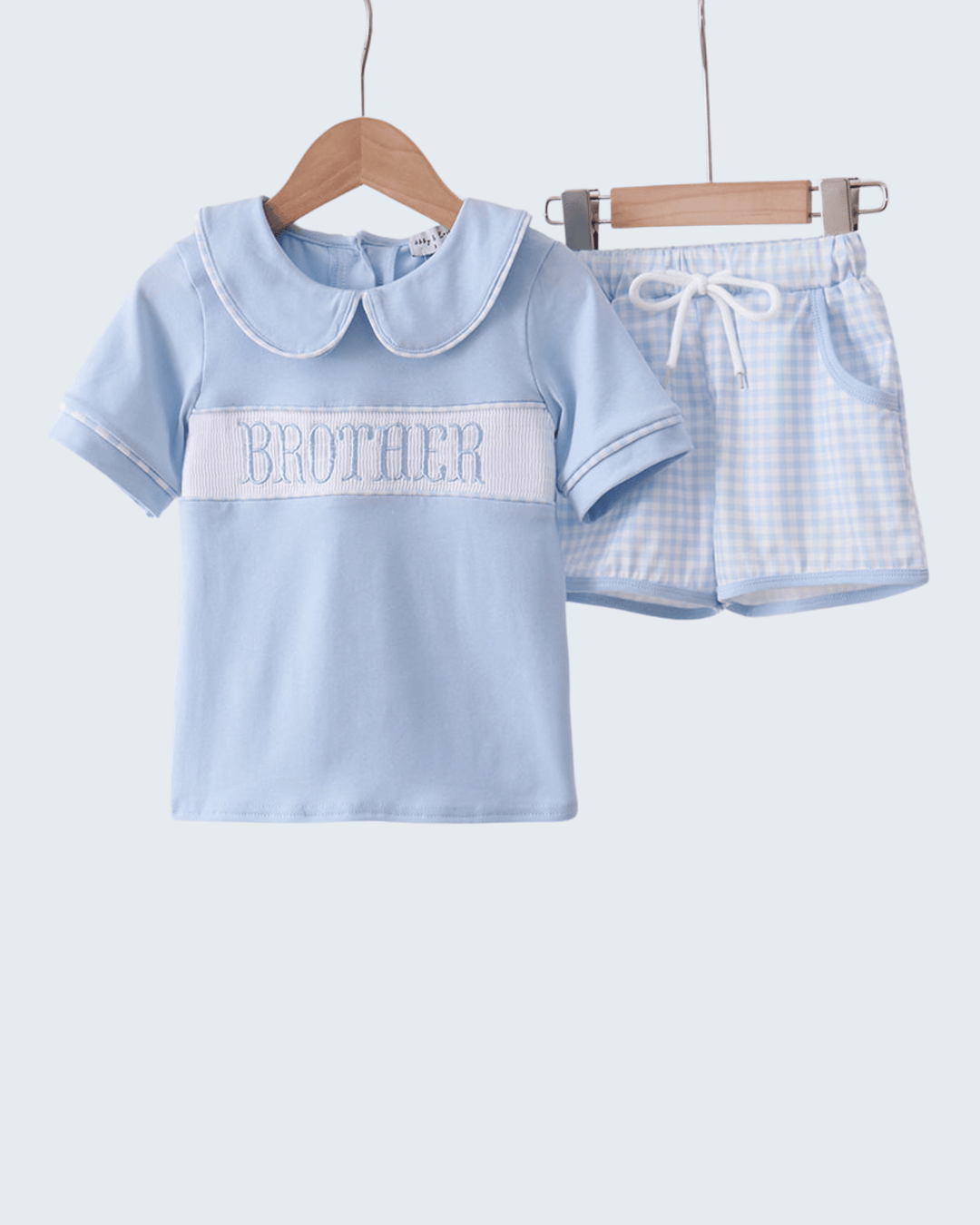 Children's blue outfit with 'BROTHER' text on a white background