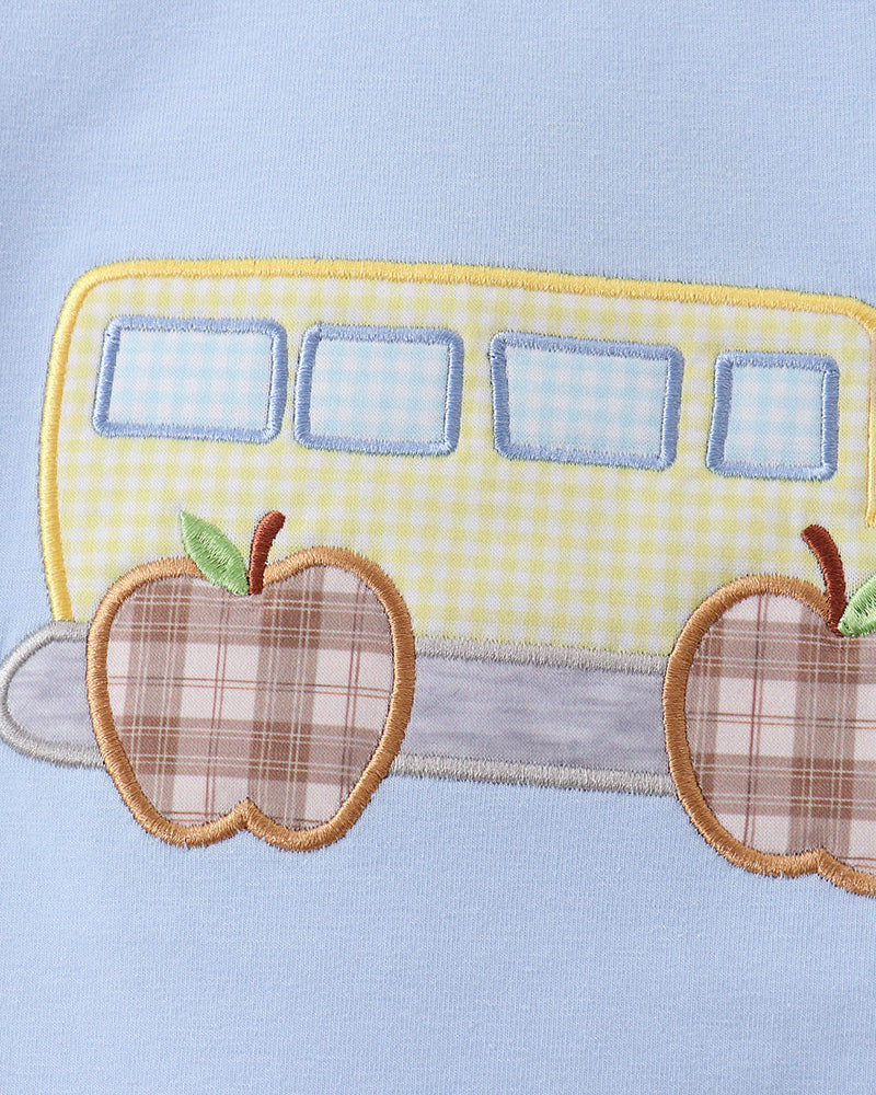 Light blue T-shirt with appliqued bus design and two apple patches