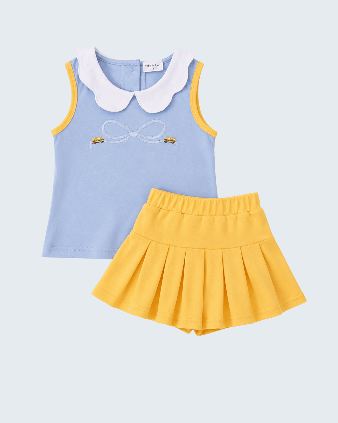 Blue sleeveless top with Peter pan collar and embroidered bow, with yellow ruffle skort