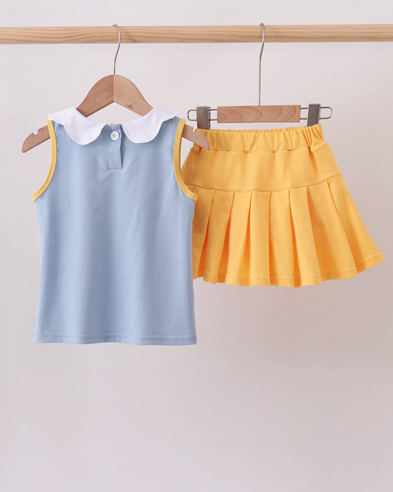 Light blue sleeveless top with white collar and yellow ruffle skort set, front view