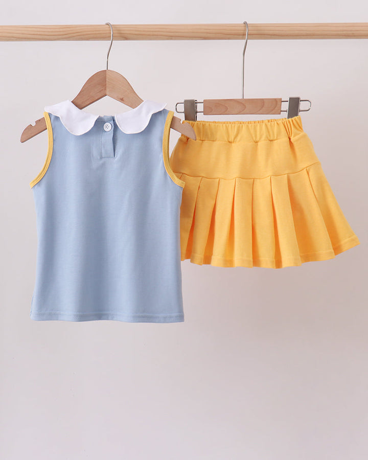 Light blue sleeveless top with white collar and yellow ruffle skort set, front view