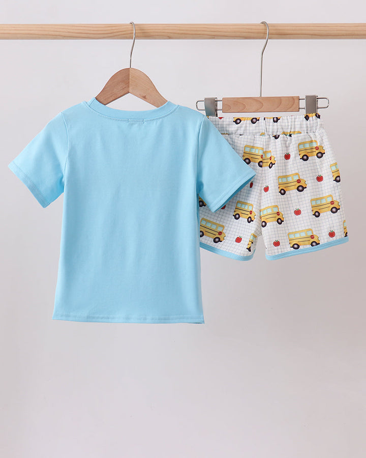 Light blue kids T-shirt with bus graphic and matching shorts on hangers
