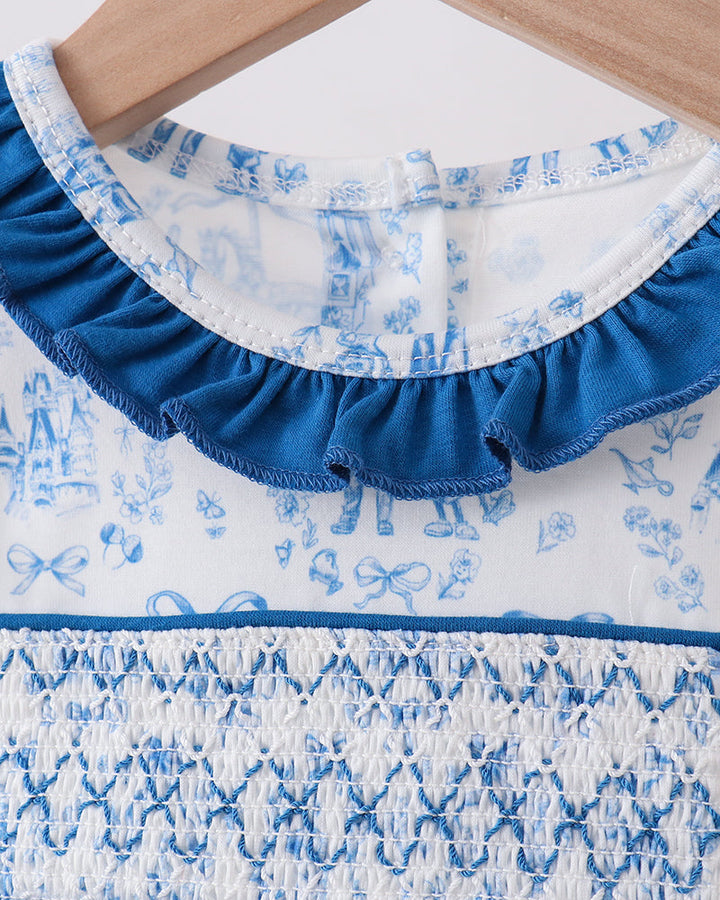 Close-up of a blue and white patterned fabric with ruffled edge.