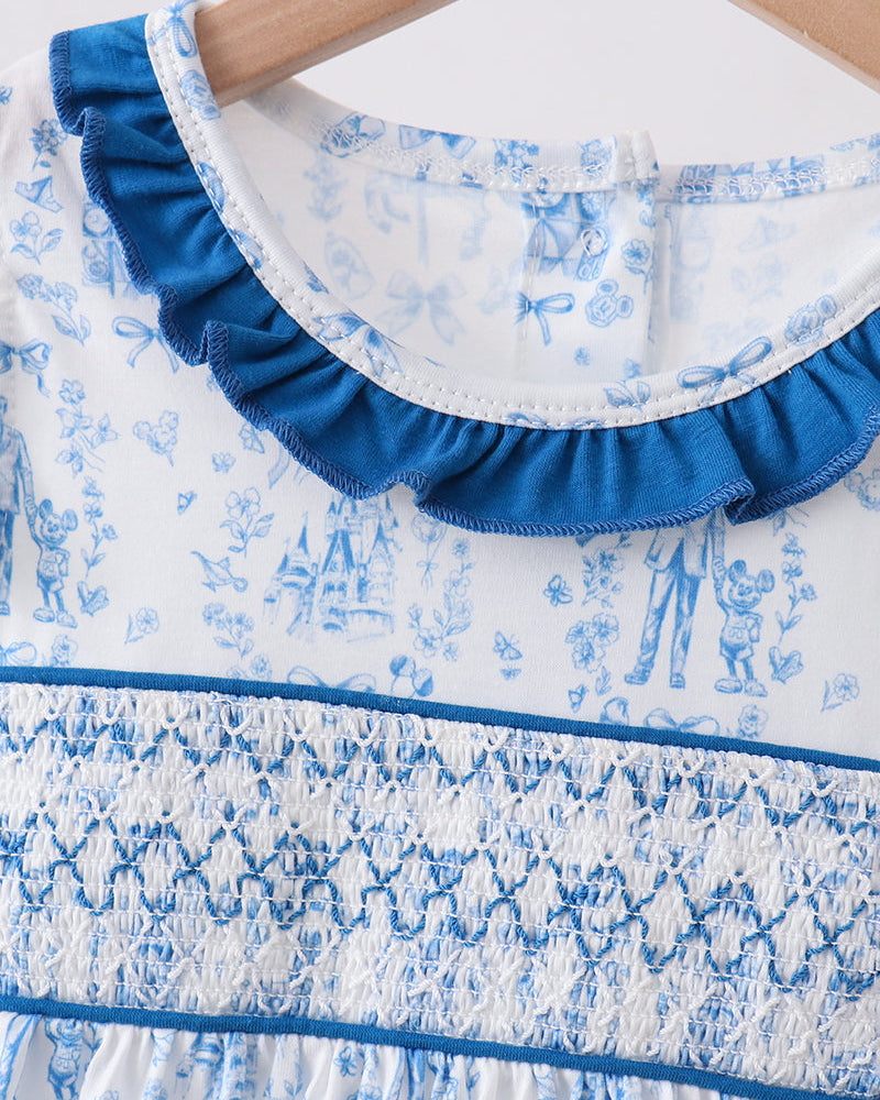 Close-up of a blue and white patterned dress with ruffled collar.