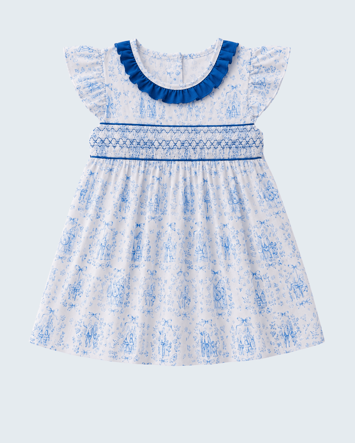 White dress with blue floral pattern and ruffled neckline on a light gray background