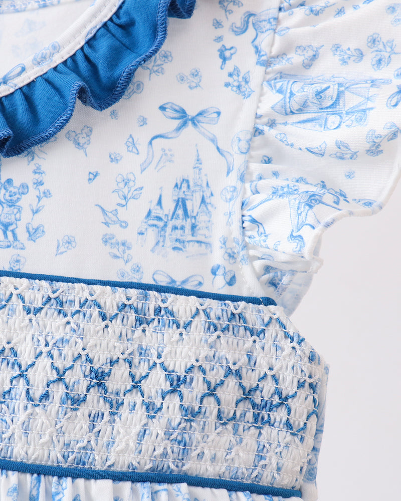 Close-up of a blue and white floral dress with ruffled details.