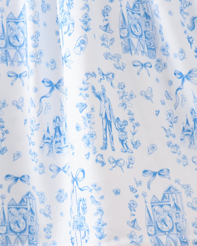 White fabric with blue vintage-style pattern featuring people, clocks, and bows.