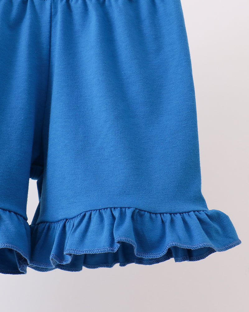 Blue shorts with ruffled hem on a light gray background