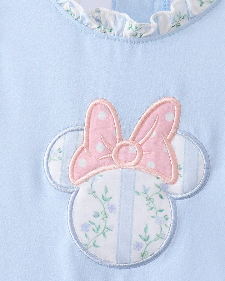 Light blue swimsuit with floral details and a pink bow on a white background