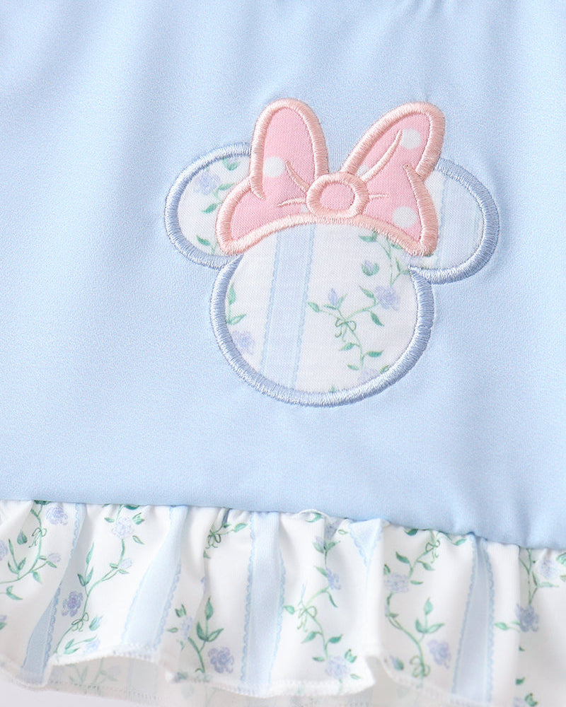 Light blue dress with floral pattern and pink bow design on a white background