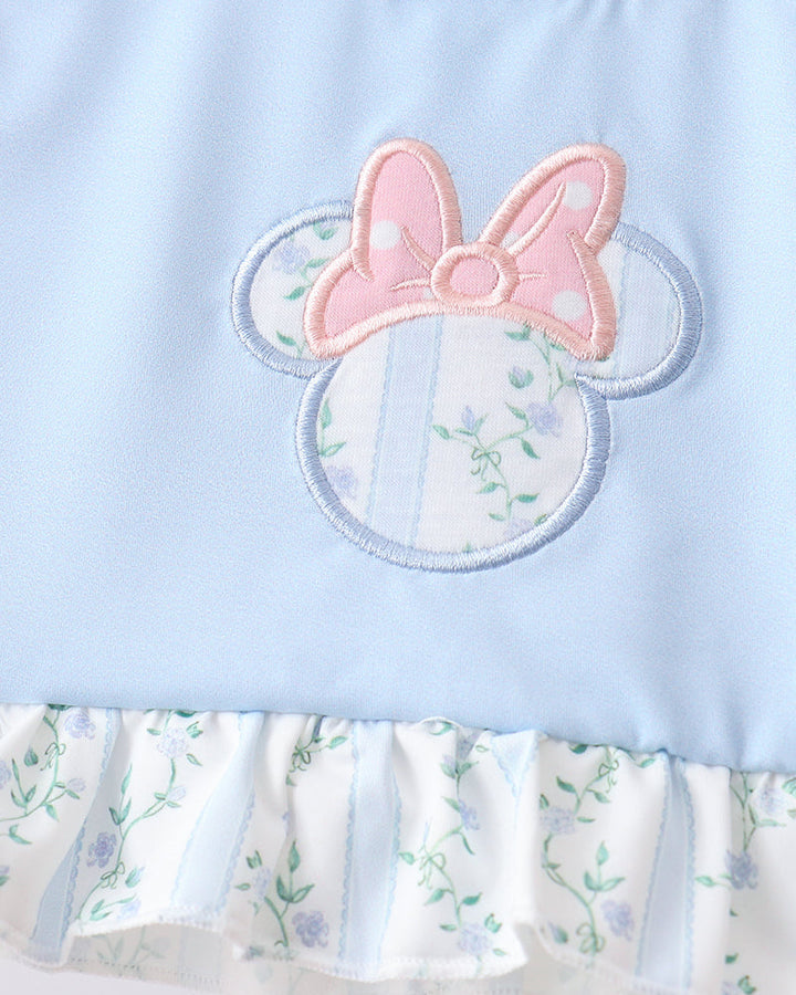 Light blue dress with floral pattern and pink bow design on a white background