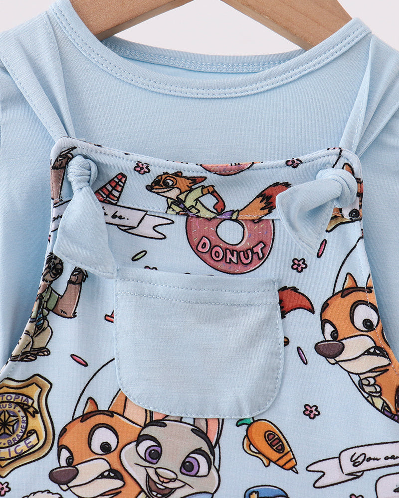 Light blue romper close-up with character-print bib pocket and button tabs