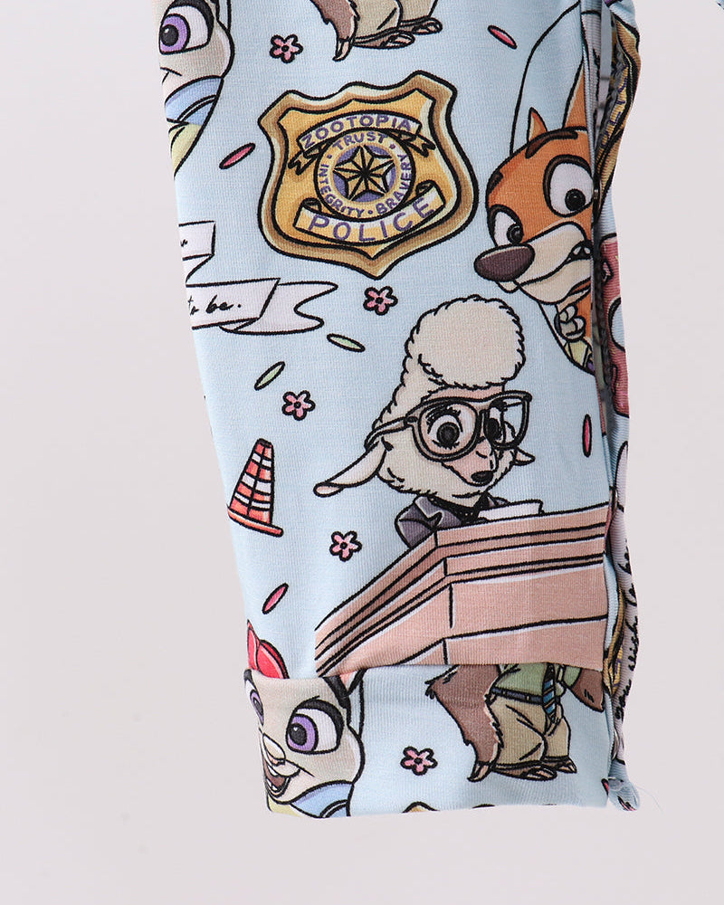 Light blue bamboo romper with scattered animal character print and elastic leg cuffs