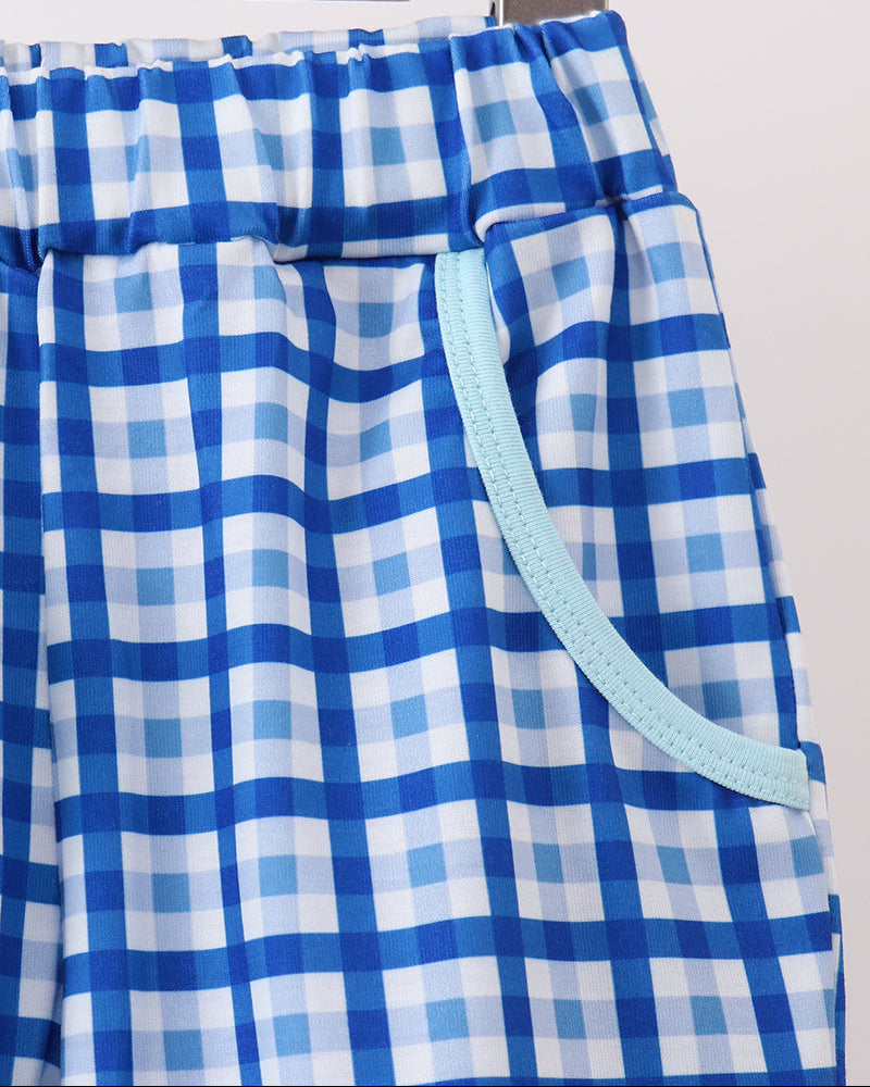 Blue and white plaid pants with elastic waistband and light blue contrast trim