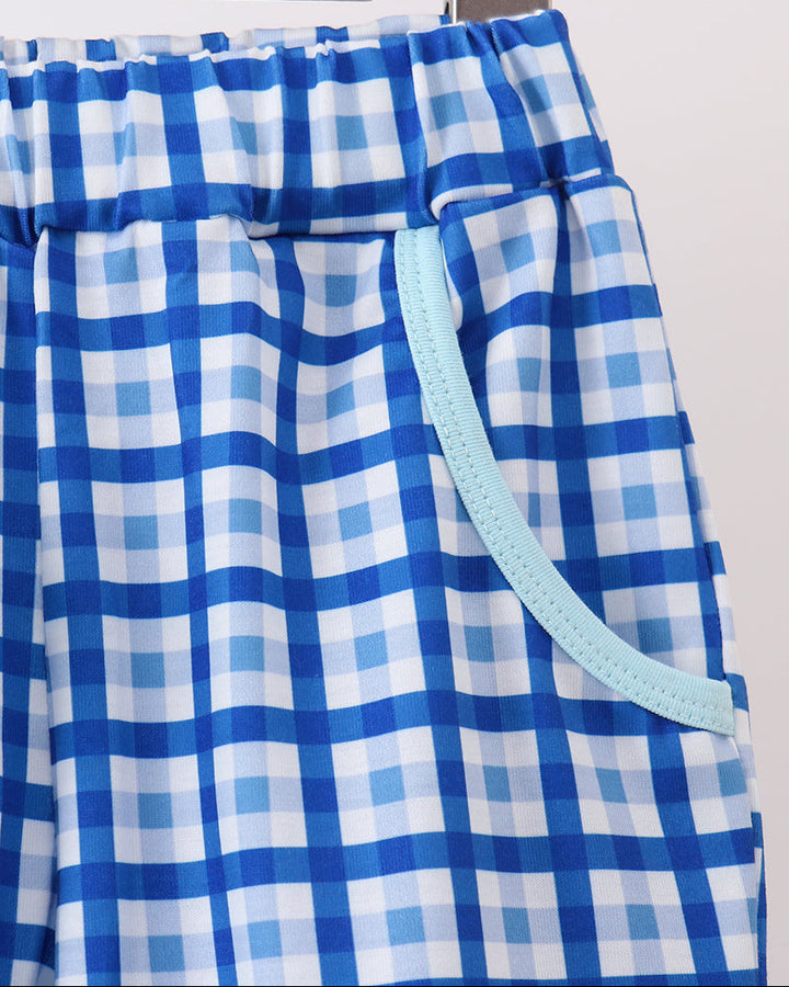 Blue and white plaid pants with elastic waistband and light blue contrast trim