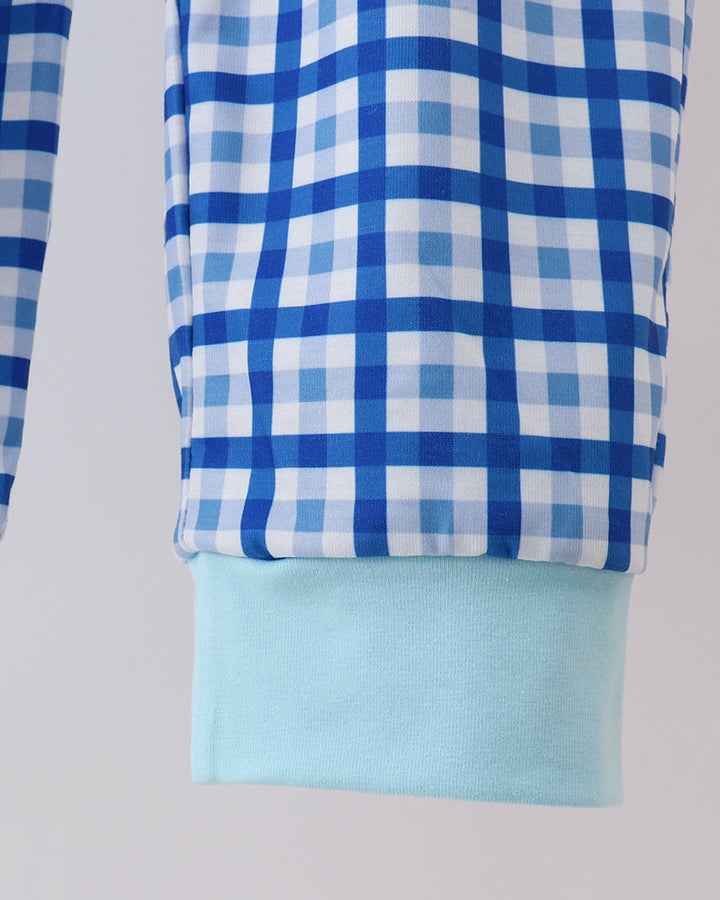Blue plaid pants legs with light blue hem cuffs at ankle