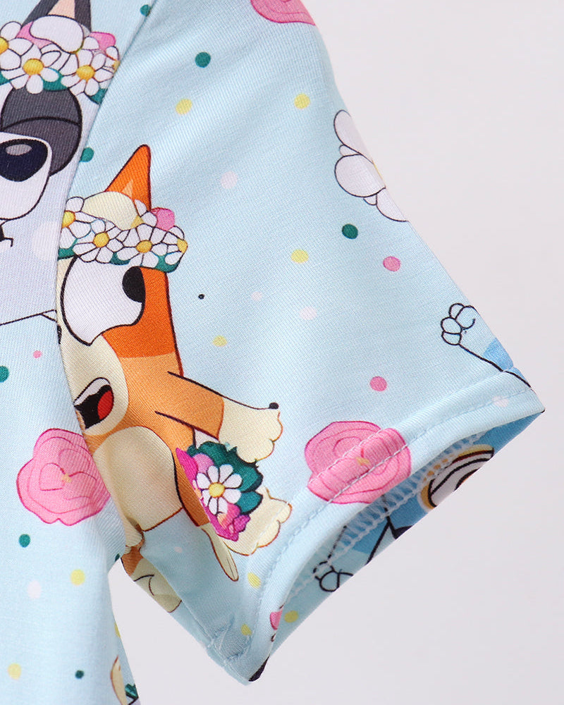 Dress with cartoon dog design on a light blue background