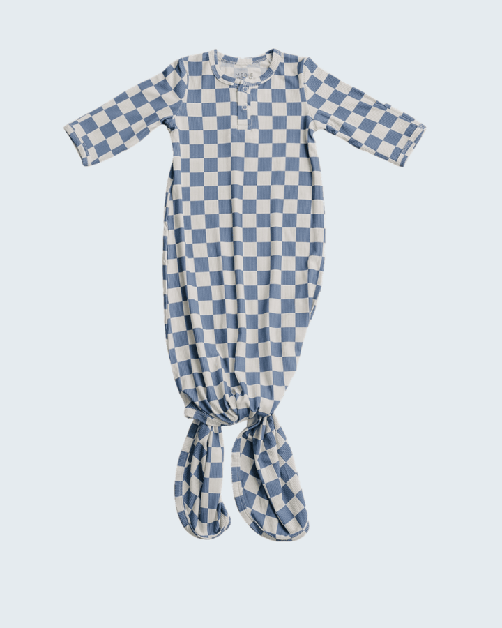 Blue and white checkered baby gown on a light blue background