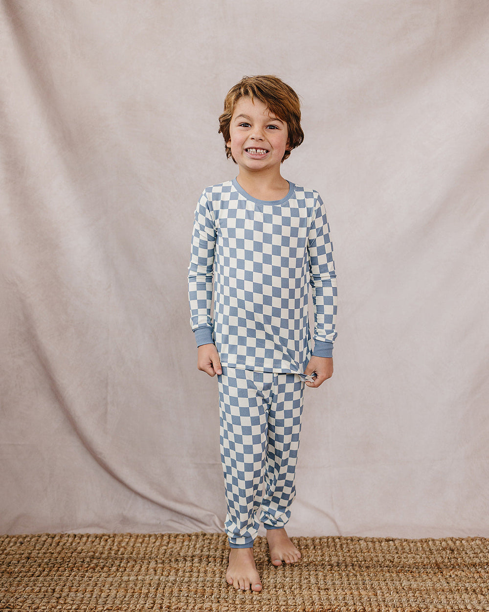 Blue checkered bamboo pajama set with long-sleeve top and matching pants on a child