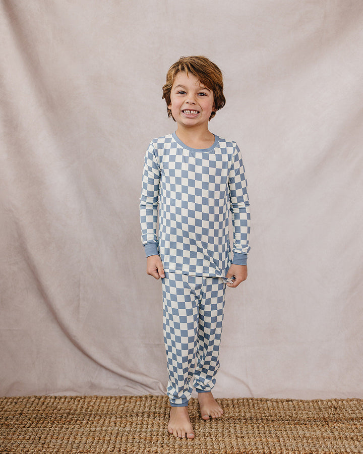 Blue checkered bamboo pajama set with long-sleeve top and matching pants on a child