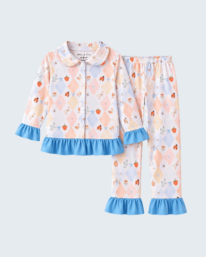 Kids bamboo pajama set with blue ruffle cuffs, button shirt and printed pajama pants
