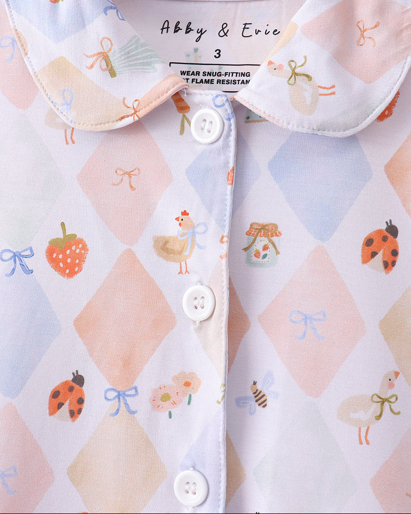Button-up pajama top with Peter Pan collar, pastel diamond pattern and fruit-and-bow print