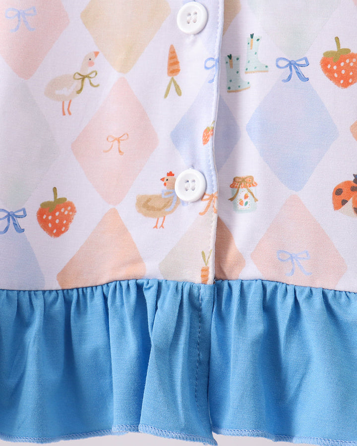 Pastel diamond print pajama top with white buttons and blue ruffle hem