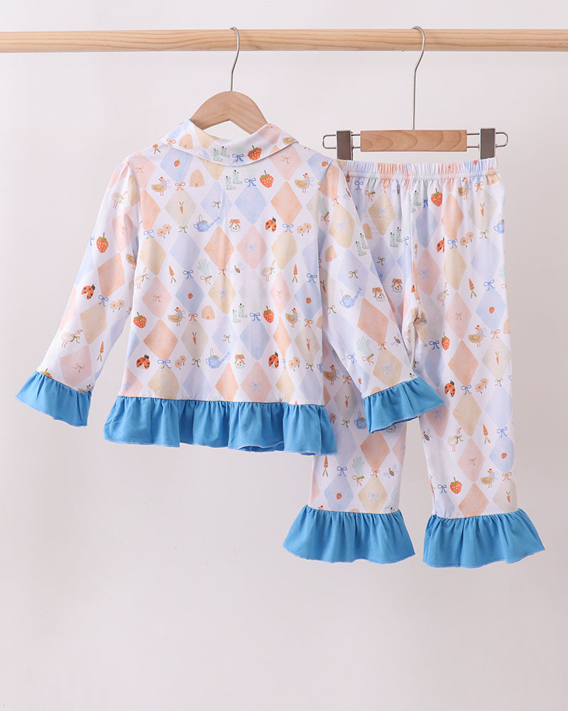Kids pajama set with pastel diamond fruit print and blue ruffle cuffs; top and matching pants