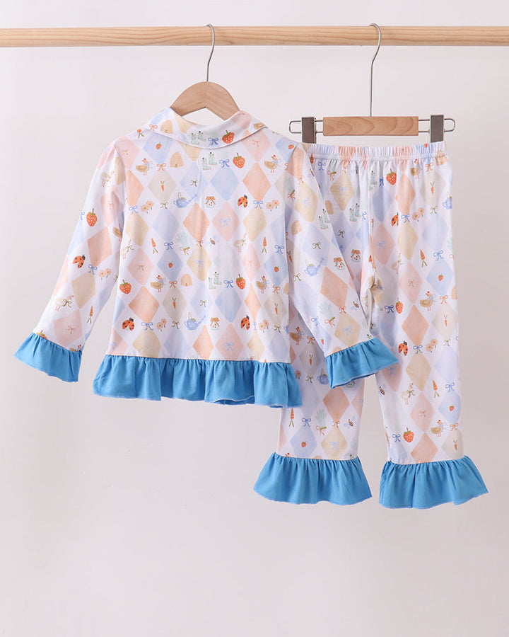 Kids pajama set with pastel diamond fruit print and blue ruffle cuffs; top and matching pants