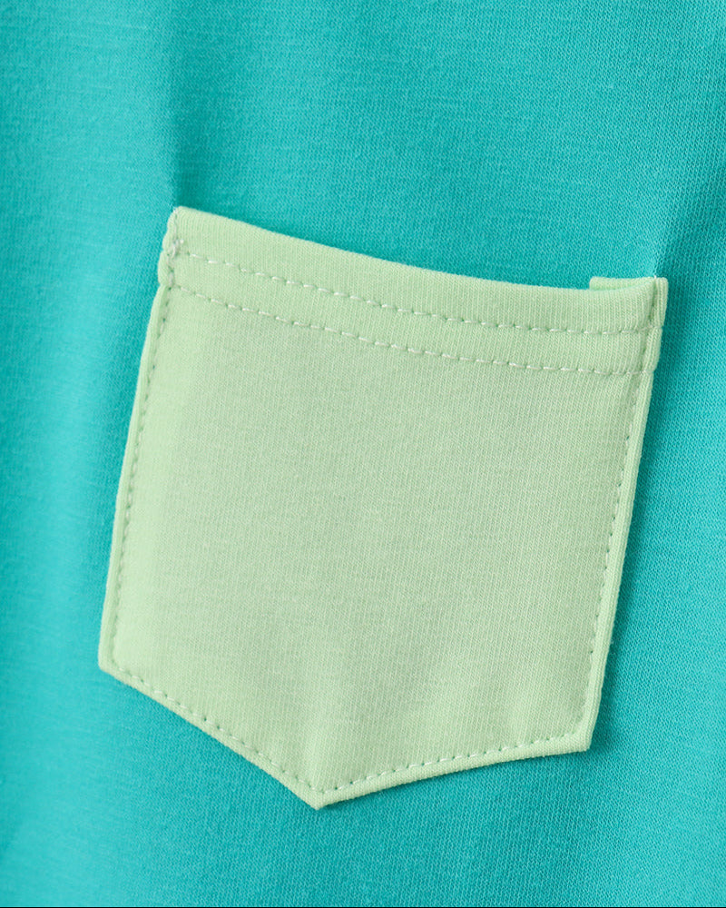 Close-up of a teal shirt with a light green pocket