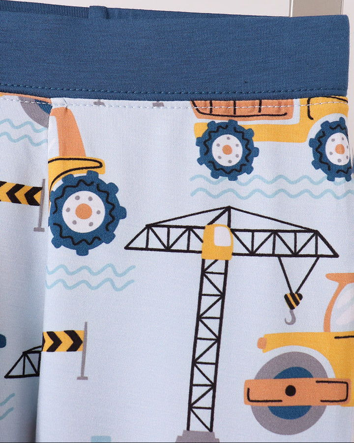 Pajama pants waistband and hem detail with dark blue trim and construction crane graphic