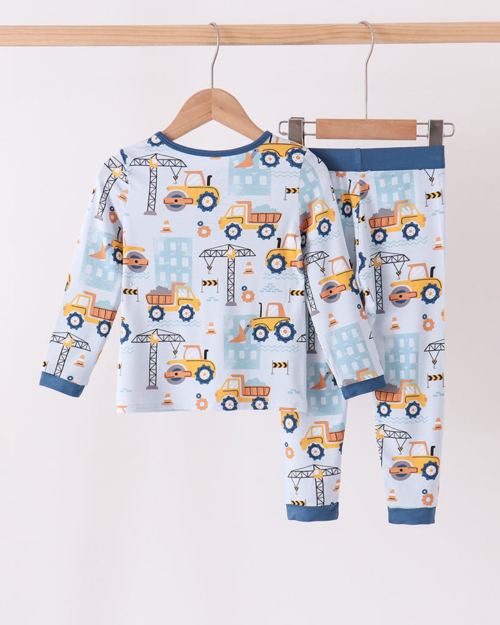 Kids bamboo pajama set with full top and pants, construction truck pattern and dark blue trim
