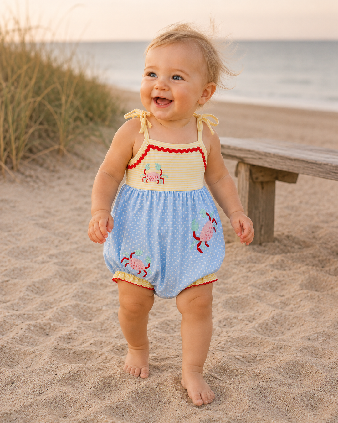 Baby girl walking on the beach