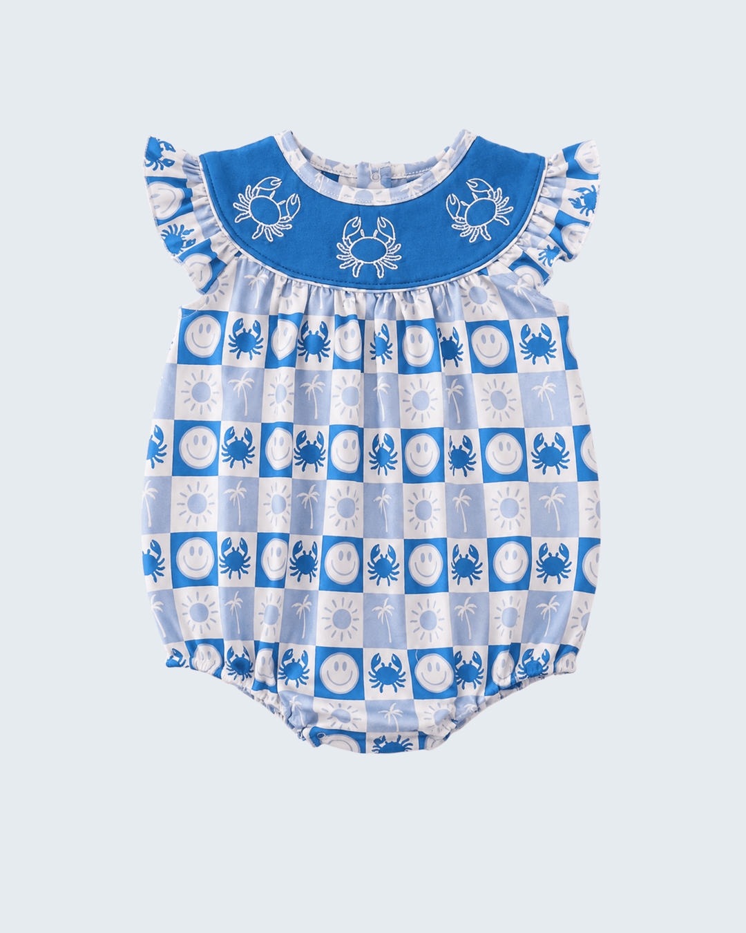 A baby romper with a blue and white checkerboard pattern featuring crabs and sun motifs, complete with a solid blue ruffled collar decorated with embroidered crabs.