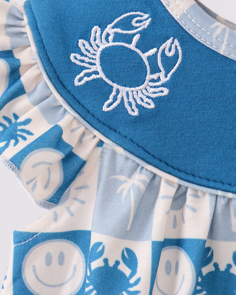 Close-up: crab embroidery on blue yoke with blue-and-white checkered bubble romper