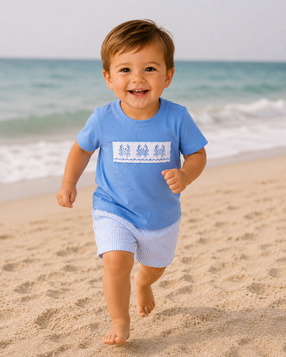 toddler boy running on the beach