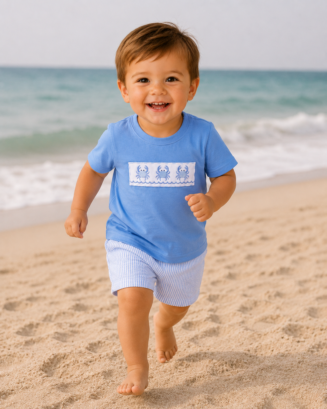 toddler boy running on the beach