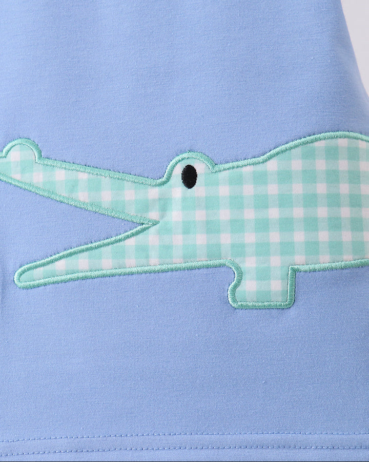 Light blue T-shirt with green plaid crocodile applique and stitched details