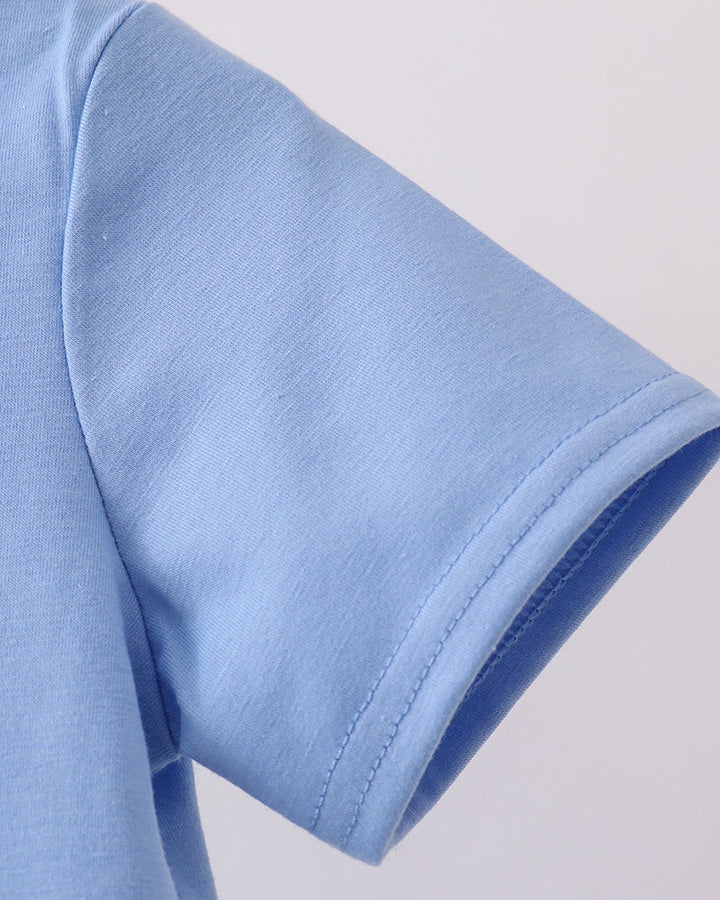 Light blue T-shirt sleeve with visible stitched hem and seam