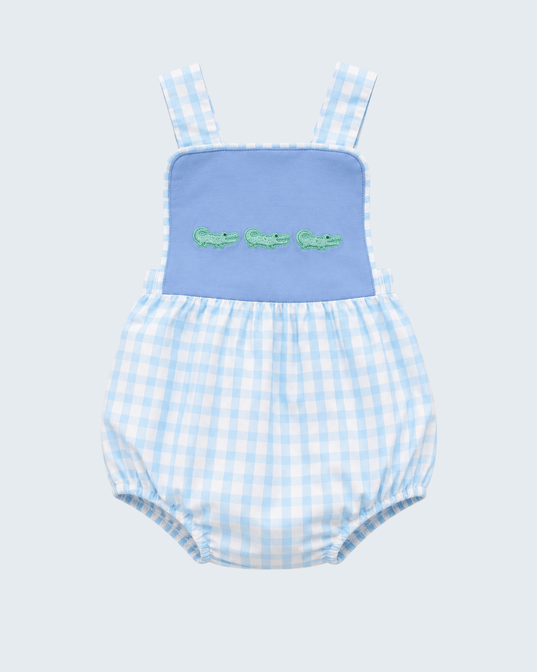 Blue bib bubble romper with green crocodile embroidery over light blue check