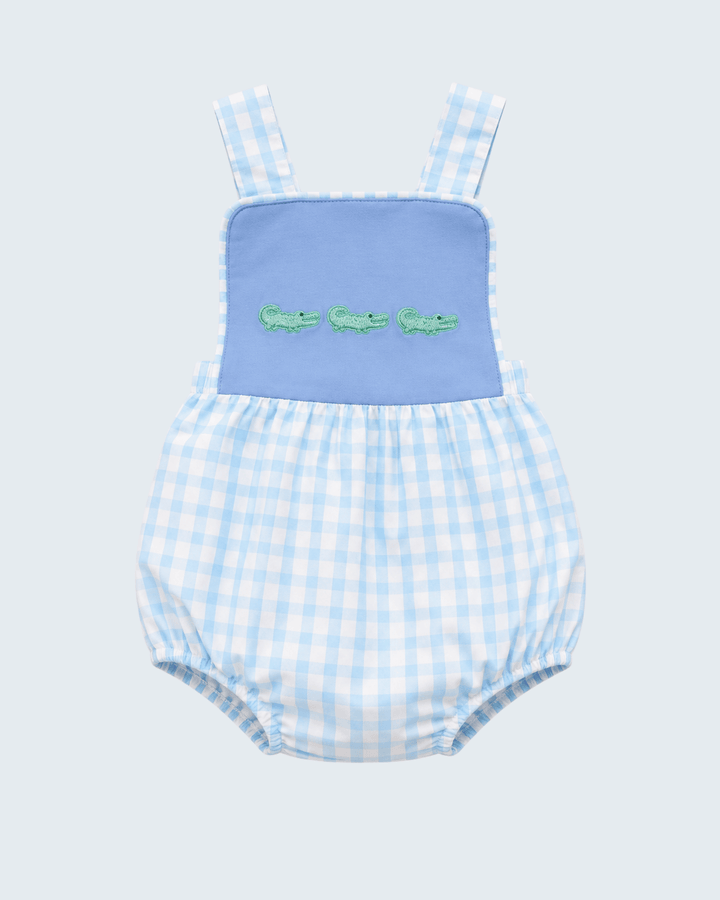 Blue bib bubble romper with green crocodile embroidery over light blue check