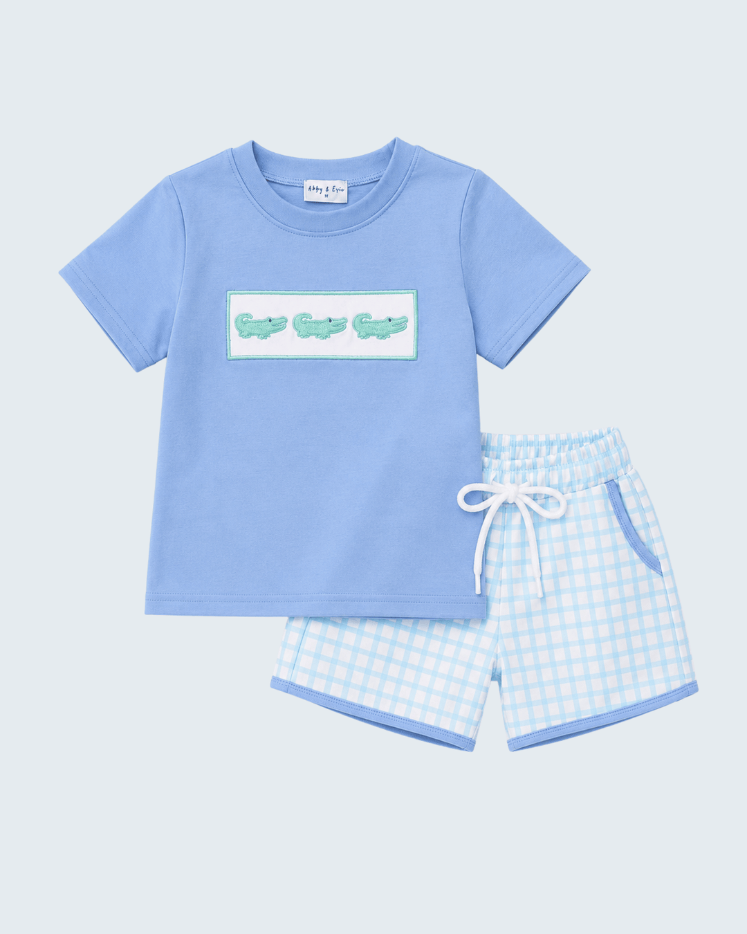 Light blue T-shirt with crocodile graphic and matching checkered shorts