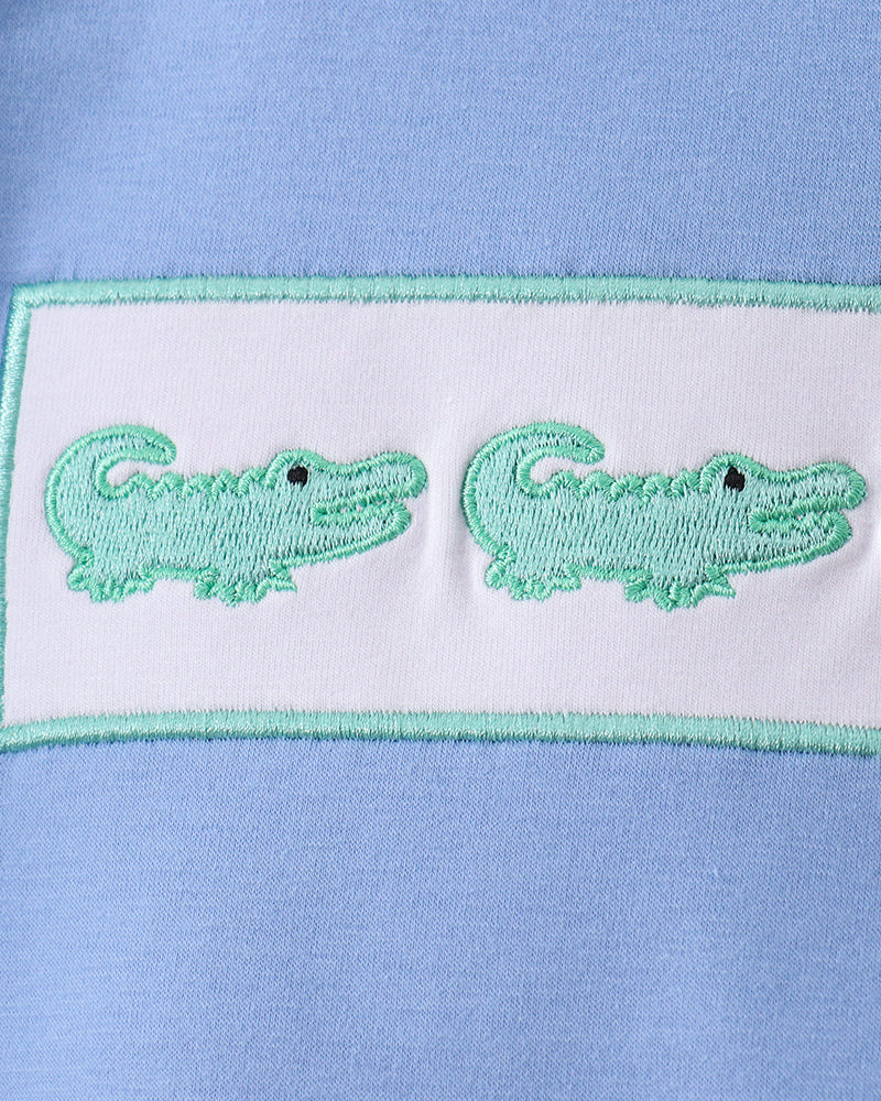 Green crocodile embroidery on white patch with mint border